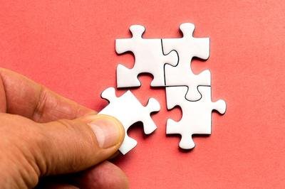 person putting together a puzzle