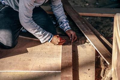 small business ERP - man measuring wood